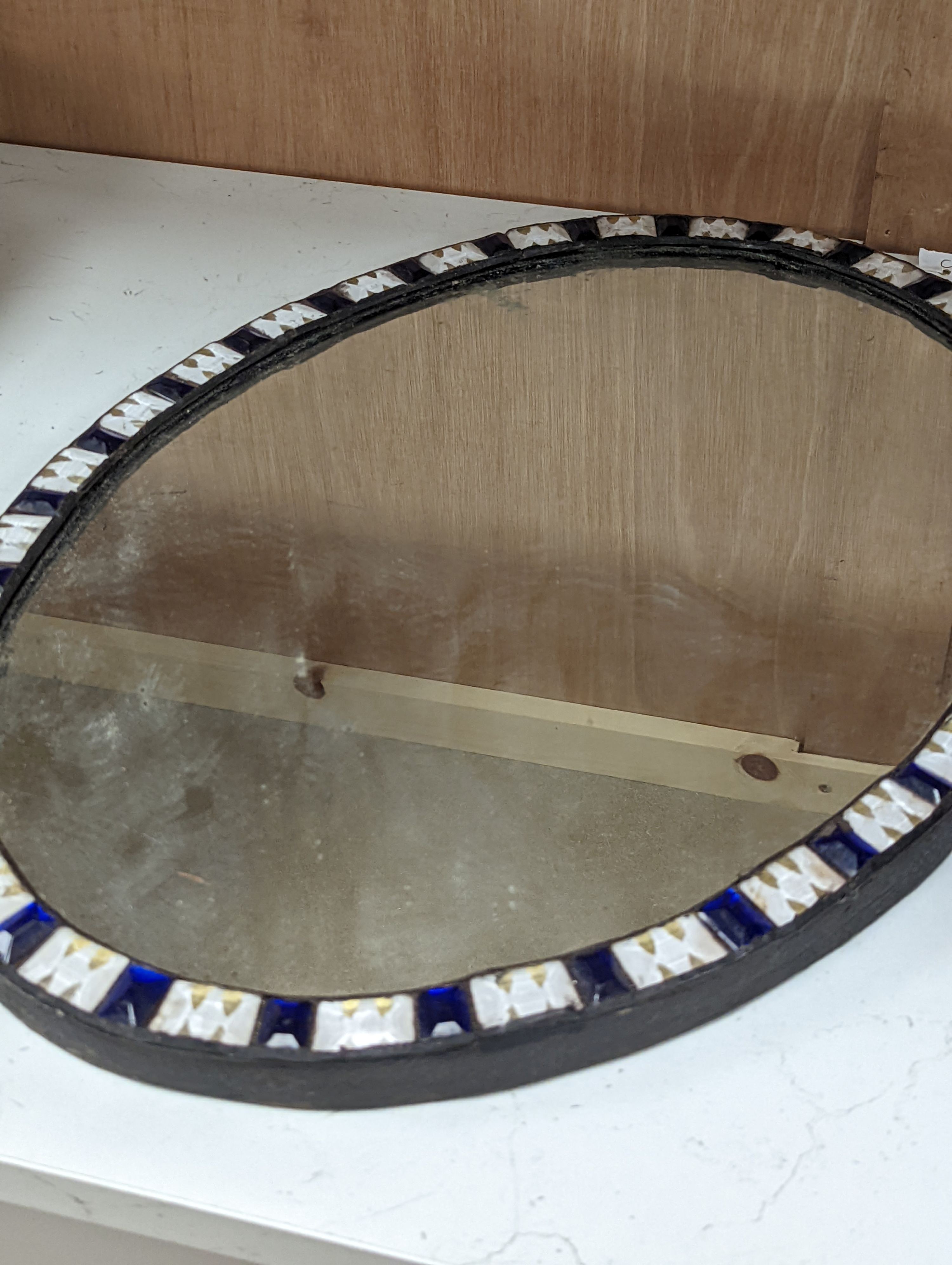 An oval Irish-style wall mirror, 56x41cm
